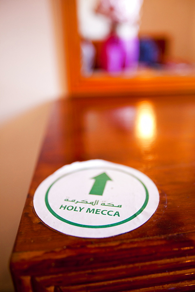 An arrow pointing towards Mecca in a hotel room in Marrakech, Morocco, North Africa, Africa