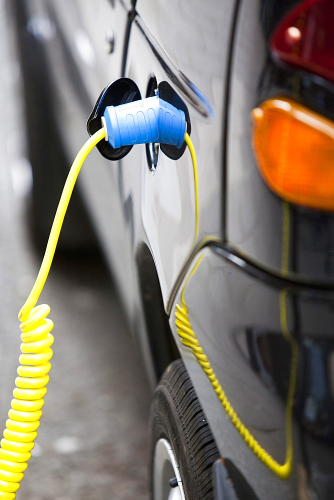 An electric vehicle at a recharging station on the street in Berkeley Square, London, England, United Kingdom, Europe