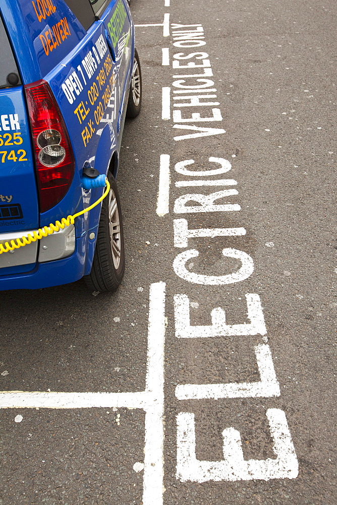 An electric vehicle at a recharging station on the street in Berkeley Square, London, England, United Kingdom, Europe