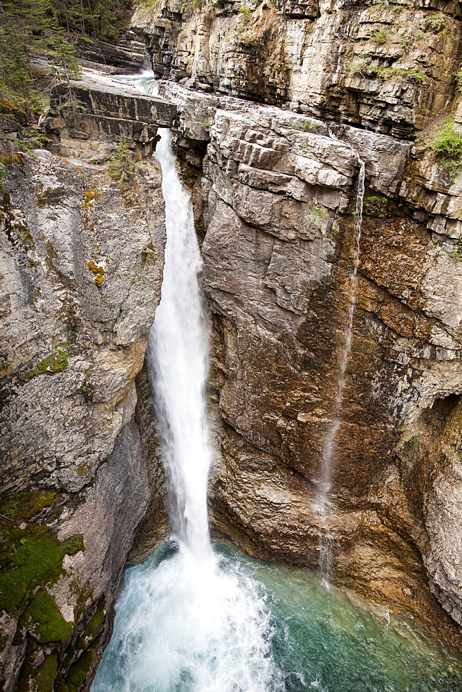 A waterfall in Johnsons Canyon in the Banff National Park, UNESCO World Heritage Site, Canadian Rockies, Alberta, Canada, North America