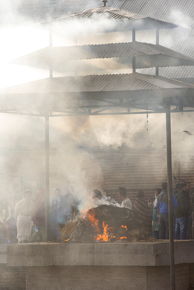 A cremation at the Pashupatinath Temple, a Hindu temple of Lord Shiva on the banks of the Bagmati River, UNESCO World Heritage Site, Kathmandu, Nepal, Asia