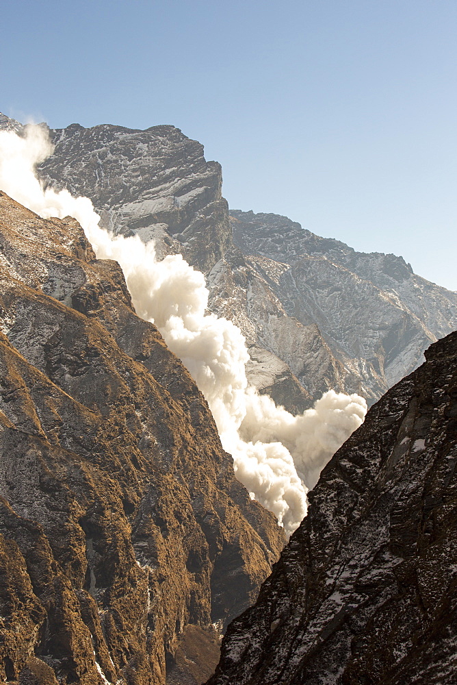 An avalanche on Machapuchare (Fishtail Peak) in the Annapurna Himalaya, Nepal, Asia