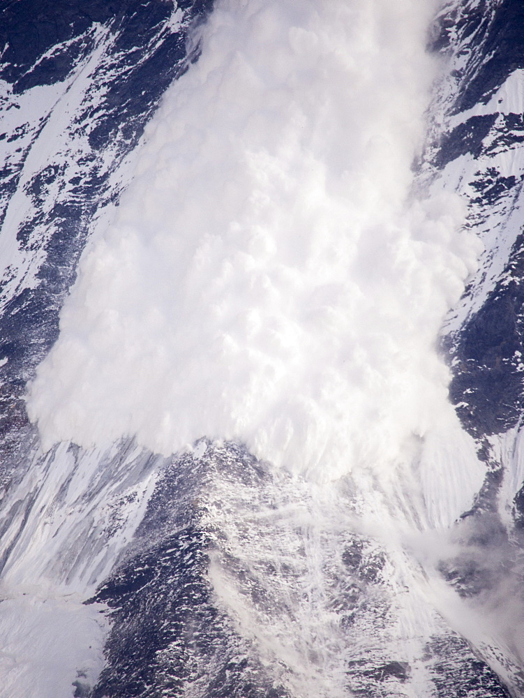 An avalanche on Machapuchare (Fishtail Peak) in the Annapurna Himalaya, Nepal, Asia