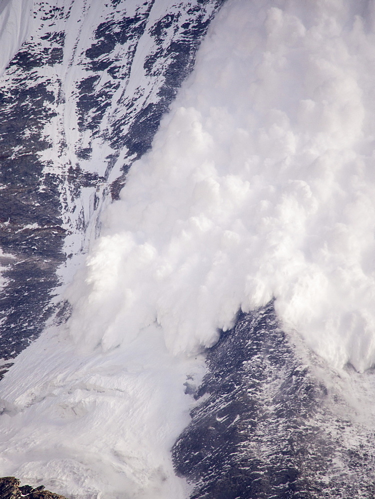 An avalanche on Machapuchare (Fishtail Peak) in the Annapurna Himalaya, Nepal, Asia