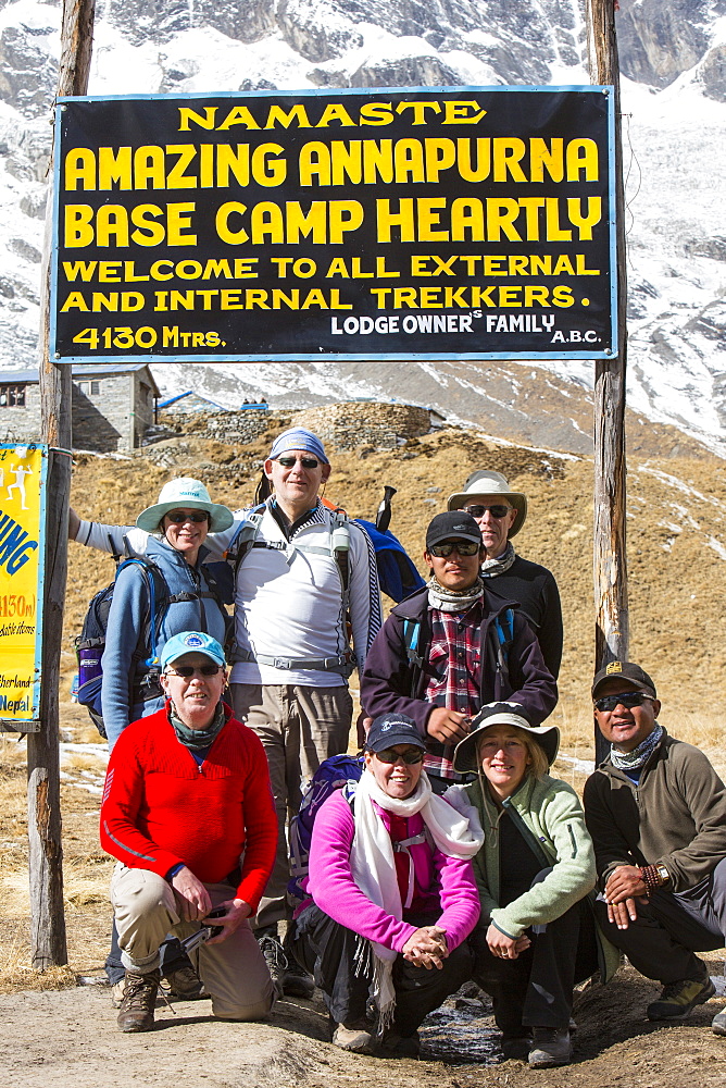 A trekking group at Annapurna Base Camp at 4130 metres in front of Annapurna South summit, Annapurna Sanctuary, Himalayas, Nepal, Asia