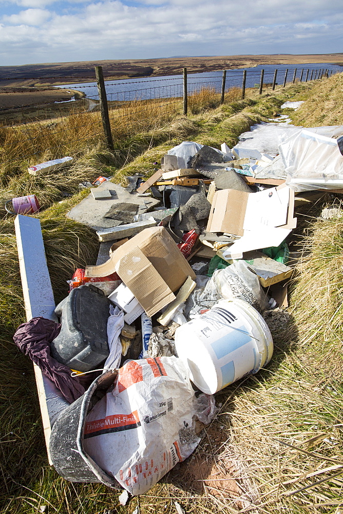 Fly tipped builders waste on Ovenden Moor near Warley Moor Reservoir above Keighley, West Yorkshire, Yorkshire, England, United Kingdom, Europe