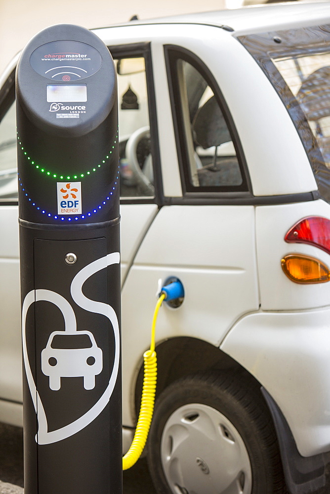 A G Wizz electric car at a pavement recharging station in London, England, United Kingdom, Europe