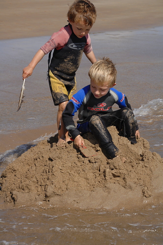 Building sandcastle, Marloes Sands, Pembrokeshire, Wales, UK