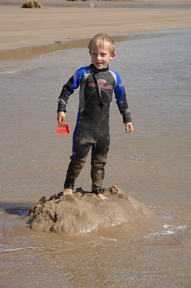 Building sandcastle, Marloes Sands, Pembrokeshire, Wales, UK