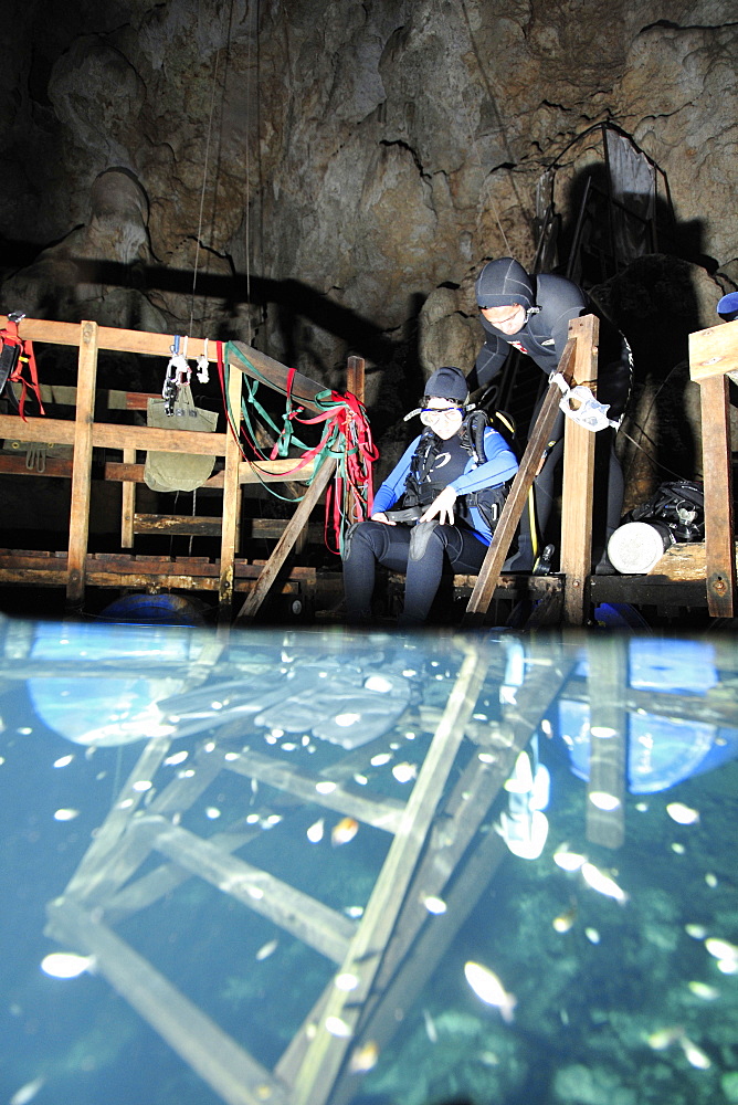 Scuba divers explore underwater cones in cave, Anhumas abyss, Bonito, Mato Grosso do Sul, Brazil, South America