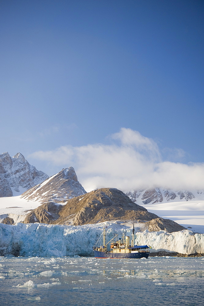 Tourist ship by Glacier face. Longyearbyne, Svalbard, Norway