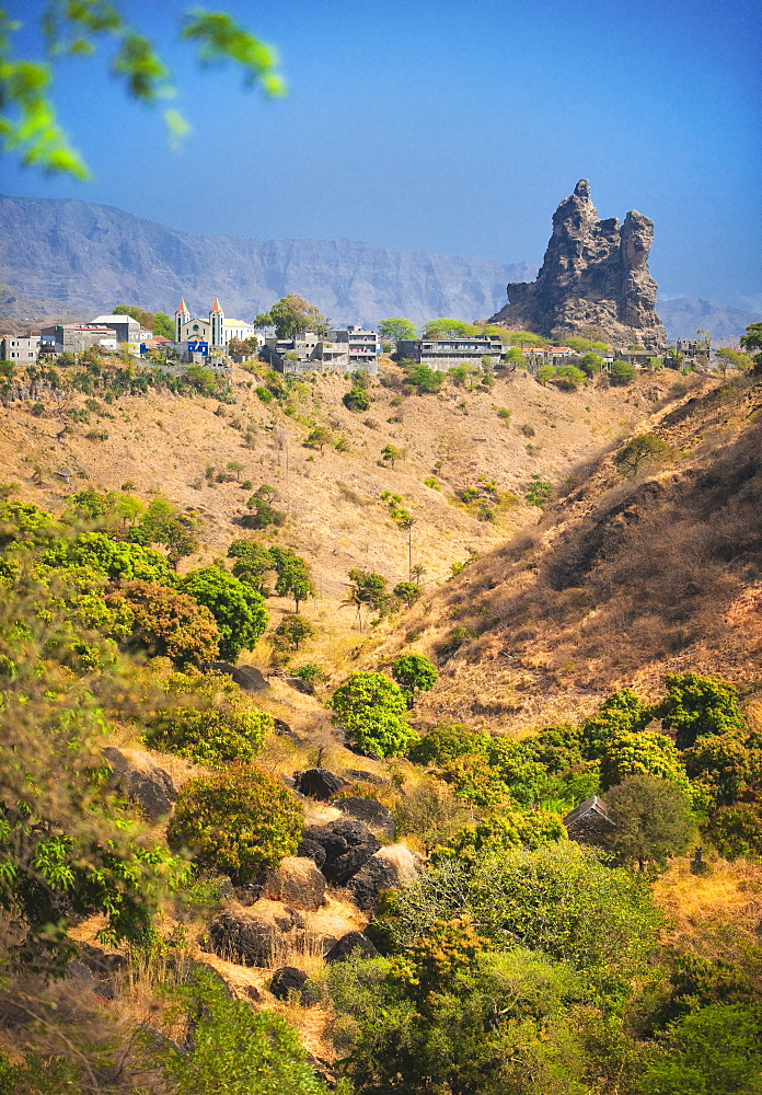 03/04/2009. The town of Picos on Sao Tiago Island of the Cape Verdes. Landscape view of volcanic formations and residential buildings with church. . Praia, Picos town, Sao Tiago Island. Cape Verde