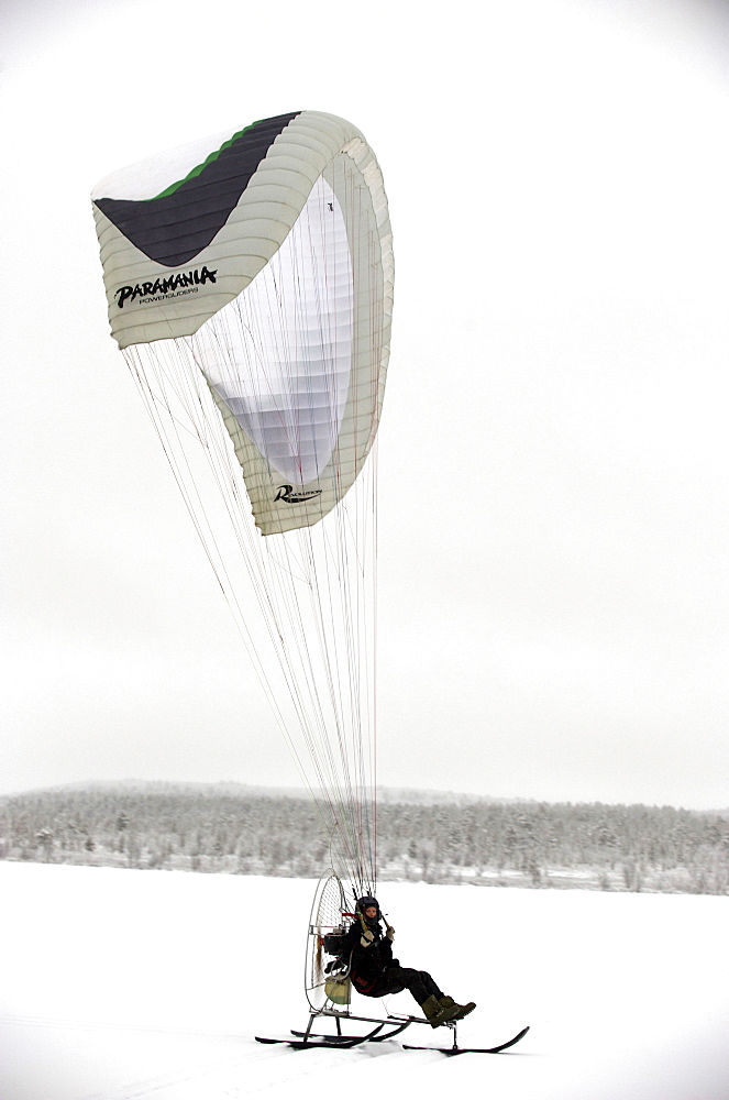 Olof Heikka a sami reindeer herdsman  on his paramotor. Lapland