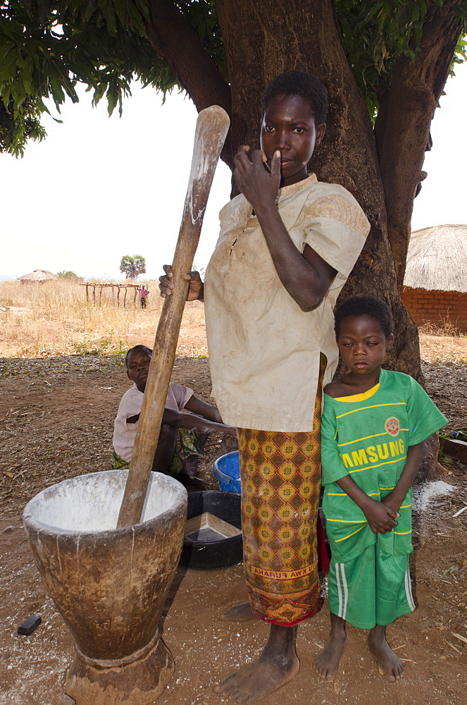 Lady pounding cassava, Talpia, Zambia, Africa