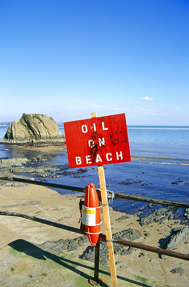 'Oil on beach' sign. Tenby beach, Wales, UK   (RR)