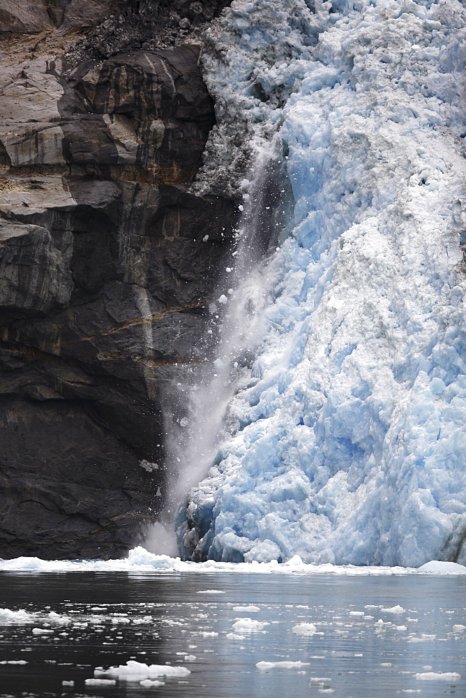 Calved icebergs and bergy bits falling from the receeding face of the Le Conte Glacier in Le Conte Bay, Southeast Alaska, USA