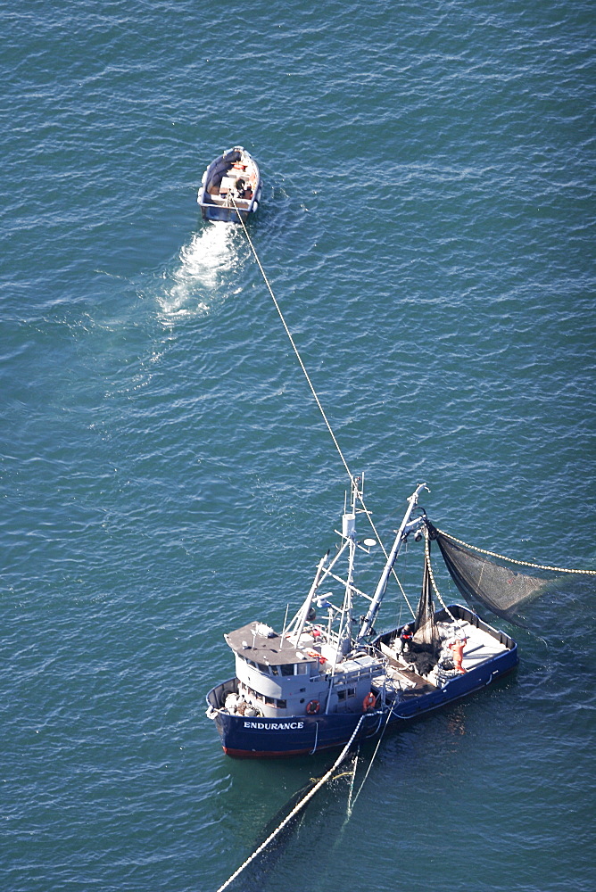 Aerial view of the purse-seiner fishery for salmon off Point Augustus, Chichagof Island, Southeast Alaska, USA. Skiff keeping the big boat out of the net.   (RR)