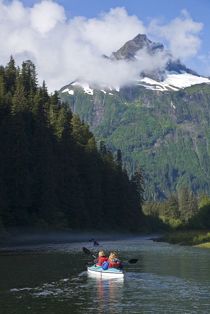 Kayaking in Red Bluff Bay on Baranof Island in Southeast Alaska, USA. Pacific Ocean. Kayak property release is DB051905. Model released numbers BM0807, JP0807, or DP0807.