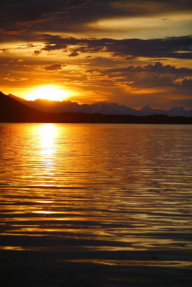 View of the shoreline at sunset from Colt Island in Stephen's Passage of Admiralty Island, Southeast Alaska, USA. Pacific Ocean.