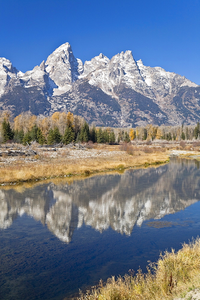 Reflected light on water from the Grand Teton Mountain Range, outside of Jackson Hole, Wyoming. This image was shot from the Schabawacker Landing on the snake river.