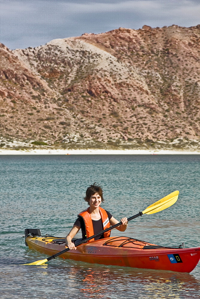 Lindblad Expeditions staff member kayaking on Isla San Francisco in the lower Gulf of California (Sea of Cortez), Baja California Norte, Mexico. Model Release #SD0408.