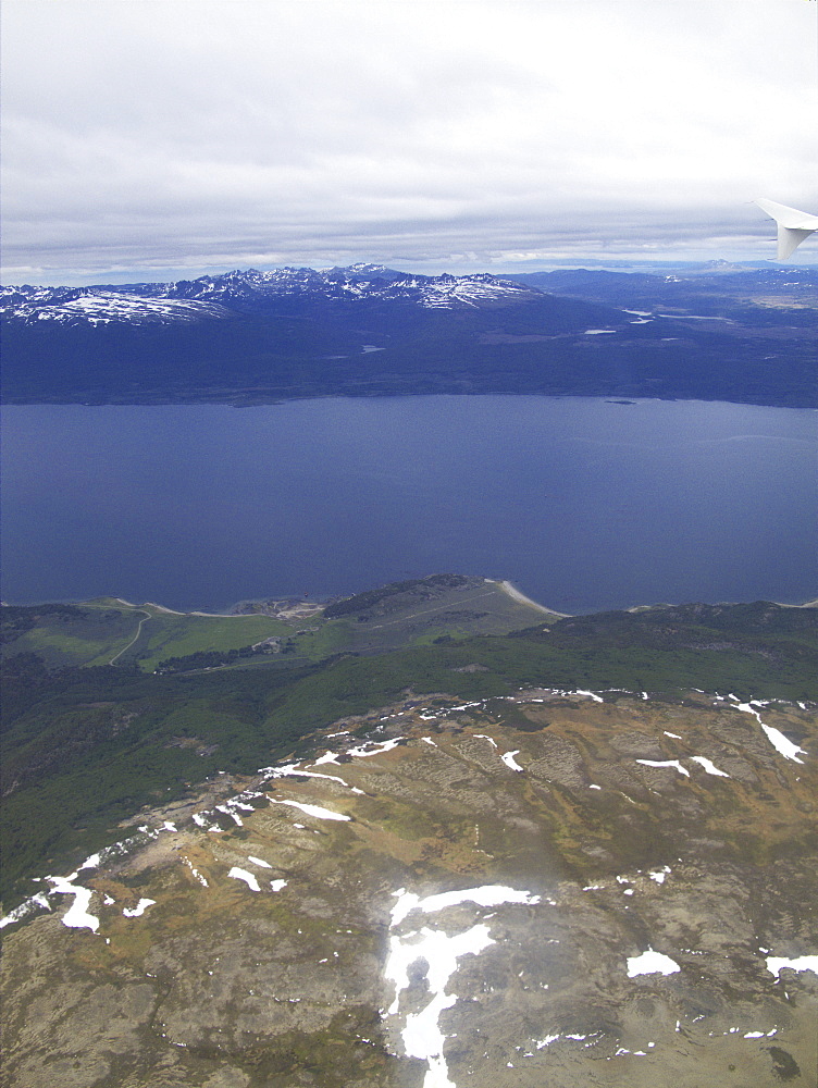 Aerial views of snow-capped mountains, ice fields, and glaciers on a charter flight from Santiago, Chile to Ushuaia, Argentina