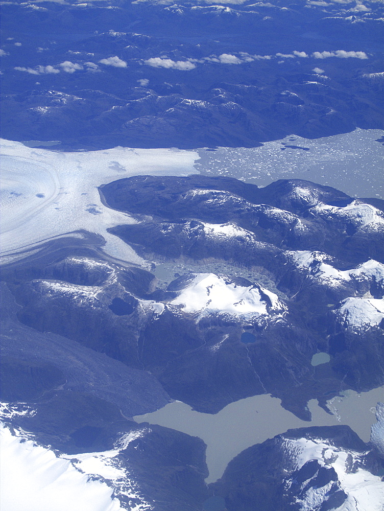 Aerial views of snow-capped mountains, ice fields, and glaciers on a charter flight from Santiago, Chile to Ushuaia, Argentina