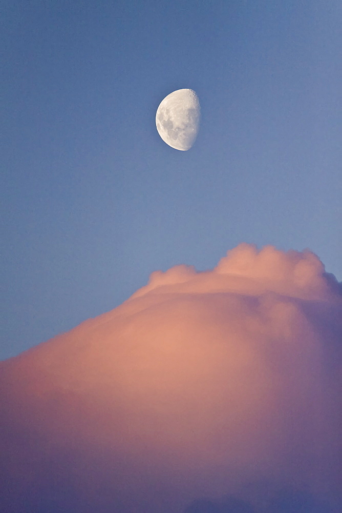 The Lindblad Expedition ship National Geographic Explorer in Dahlman Bay in late evening light as the waxing moon rises on the west side of the Antarctic Peninsula in Antarctica. 