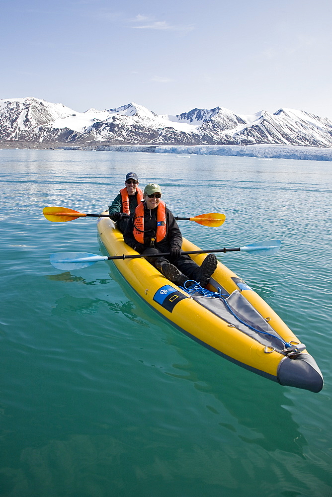 Guests from the Lindblad Expedition ship National Geographic Explorer kayaking near Monaco Glacier on Spitsbergen Island in the Svalbard Archipelago