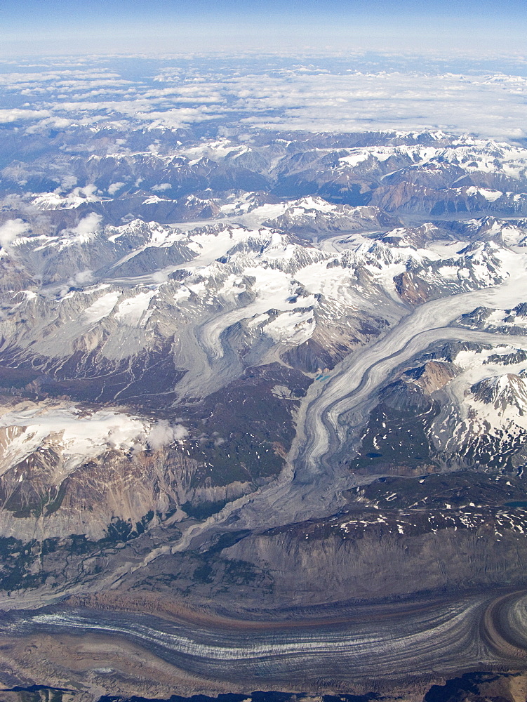 Aerial views of snow-capped mountains, ice fields, and glaciers on a commercial flight from Juneau to Anchorage Alaska, USA, Pacific Ocean