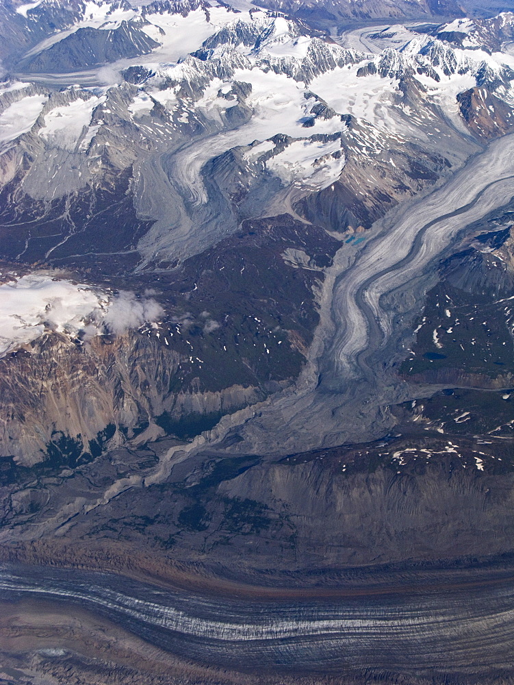 Aerial views of snow-capped mountains, ice fields, and glaciers on a commercial flight from Juneau to Anchorage Alaska, USA, Pacific Ocean