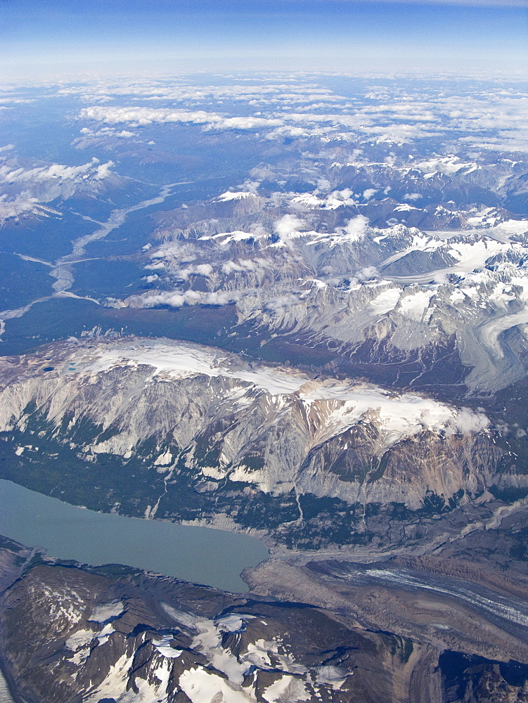 Aerial views of snow-capped mountains, ice fields, and glaciers on a commercial flight from Juneau to Anchorage Alaska, USA, Pacific Ocean