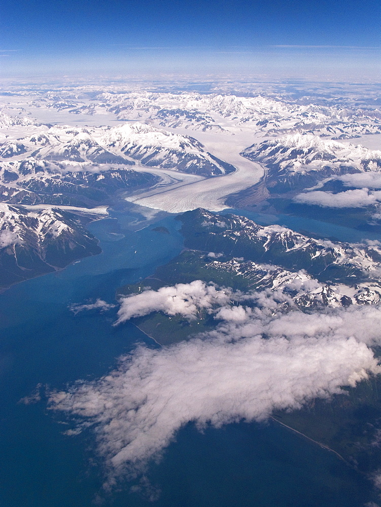 Aerial views of snow-capped mountains, ice fields, and glaciers on a commercial flight from Juneau to Anchorage Alaska, USA, Pacific Ocean