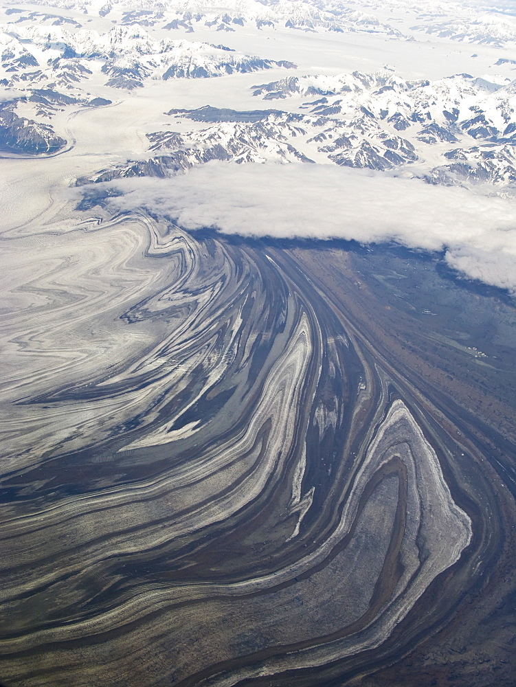 Aerial views of snow-capped mountains, ice fields, and glaciers on a commercial flight from Juneau to Anchorage Alaska, USA, Pacific Ocean