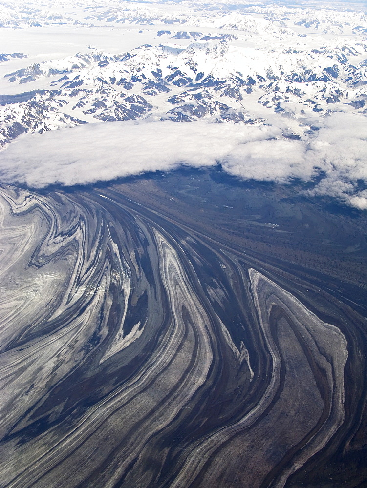 Aerial views of snow-capped mountains, ice fields, and glaciers on a commercial flight from Juneau to Anchorage Alaska, USA, Pacific Ocean