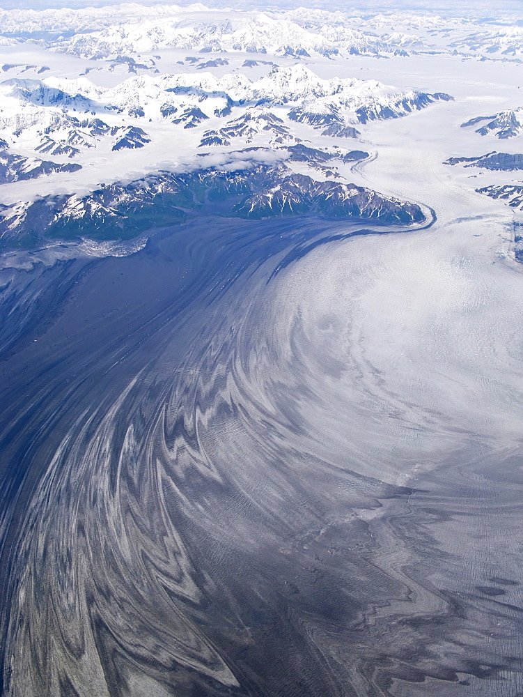 Aerial views of snow-capped mountains, ice fields, and glaciers on a commercial flight from Juneau to Anchorage Alaska, USA, Pacific Ocean