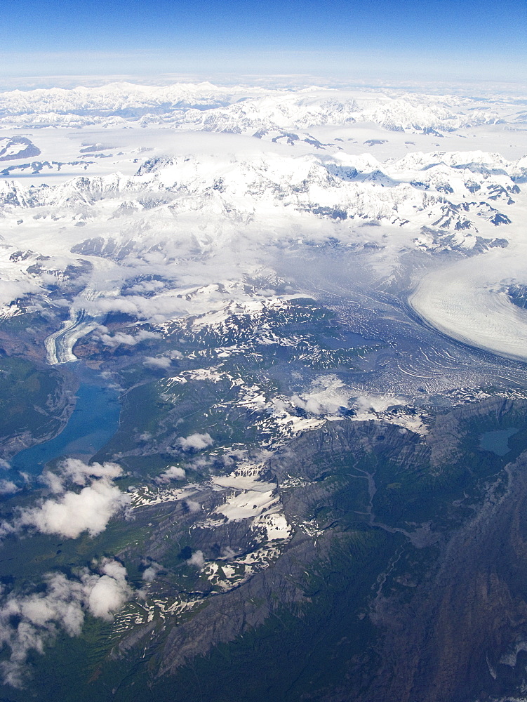 Aerial views of snow-capped mountains, ice fields, and glaciers on a commercial flight from Juneau to Anchorage Alaska, USA, Pacific Ocean