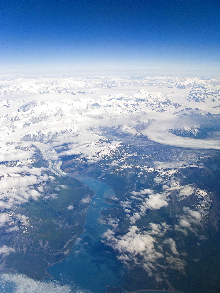 Aerial views of snow-capped mountains, ice fields, and glaciers on a commercial flight from Juneau to Anchorage Alaska, USA, Pacific Ocean