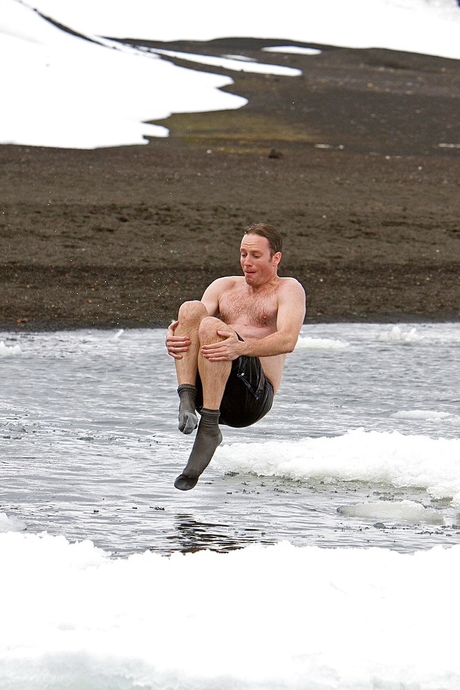 Lindblad Expeditions guests doing the "polar Plunge" in Port Foster near Whalers Bay inside the caldera on Deception Island, South Shetland Island Group, Antarctica. NO MODEL RELEASES FOR THIS IMAGE.