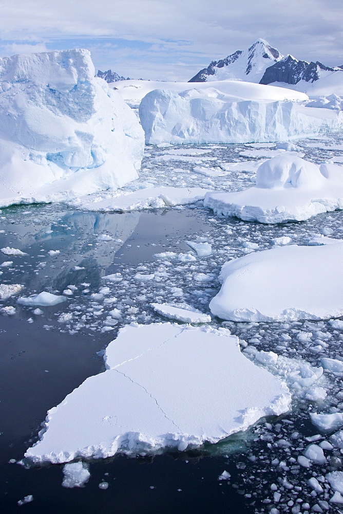 The Lindblad Expeditions ship National Geographic Explorer pushes through ice in Crystal Sound, south of the Antarctic Circle, Antarctica, Southern Ocean