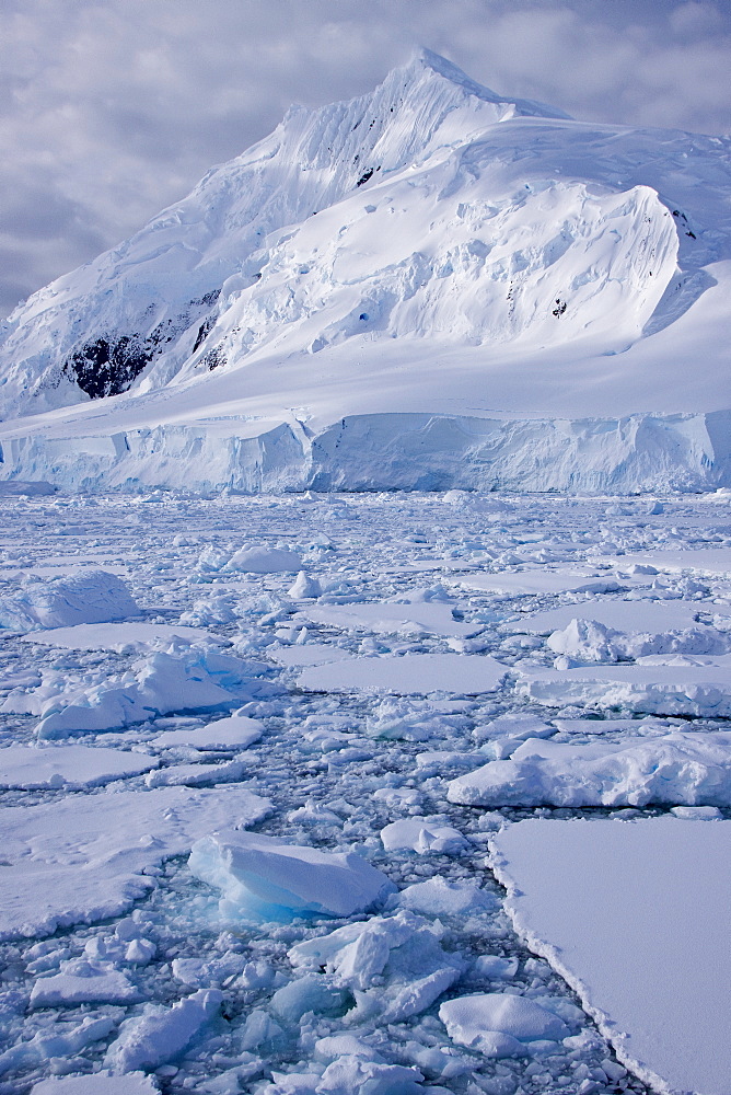 The Lindblad Expeditions ship National Geographic Explorer pushes through ice in Crystal Sound, south of the Antarctic Circle, Antarctica, Southern Ocean