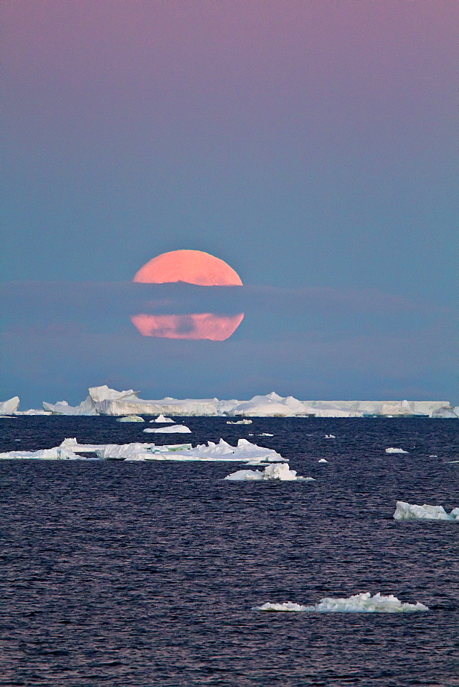 Full moon (plus 1 day) rising over icebergs in the Weddell Sea, Antarctica. MORE INFO This moonrise occurred on January 1, 2010, the night after the blue moon full of December 31, 2009.