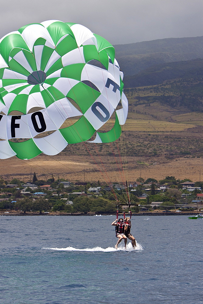 Commercial parasailing operations off the west side of the island of Maui, Hawaii, USA. MORE INFO Parasailing in Hawaii is limited seasonally to times of the year when humpback whales are not present.