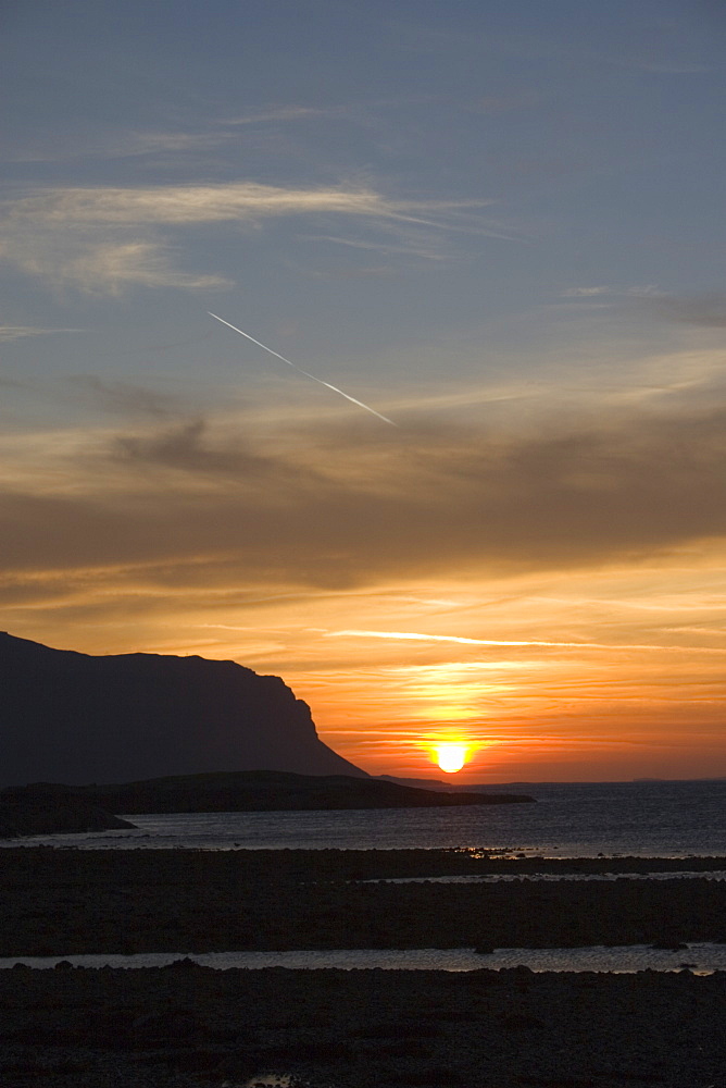 Sun setting behind the Burg Wilderness on Mull (at left), an area owned and conserved by the National Trust for Scotland.  Hebrides, Scotland