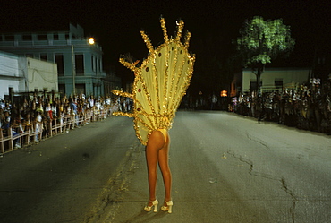 A local dancer waves to the crowd as she leads a float down Av. Victoriano Garzon during the nightly parades of Carnaval in Santiago de Cuba.