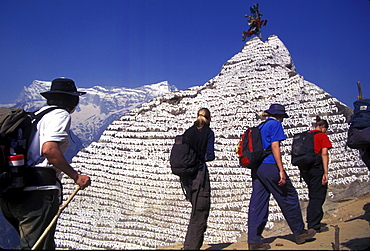 Young trekkers from New Zealand pass a stupa in Namche Bazzar while trekking in the Khumbu region (on the way to Everest), Nepal