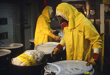 Men removing low level nuclear waste.