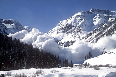 At an avalanche area near Silverton, Colorado in the San Juan Mountains a helicopter has dropped explosives to set off a slide while the road is closed. This stretch of highway receives more avalanches than any other in North America.