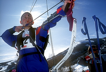 A Young participant in the relatively new sport of Ski Archery, a sport similar to biatholon but with archery instead of rifles, takes aim on a course in Park City, Utah