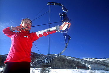 A Young participant in the relatively new sport of Ski Archery, a sport similar to biatholon but with archery instead of rifles, takes aim on a course in Park City, Utah